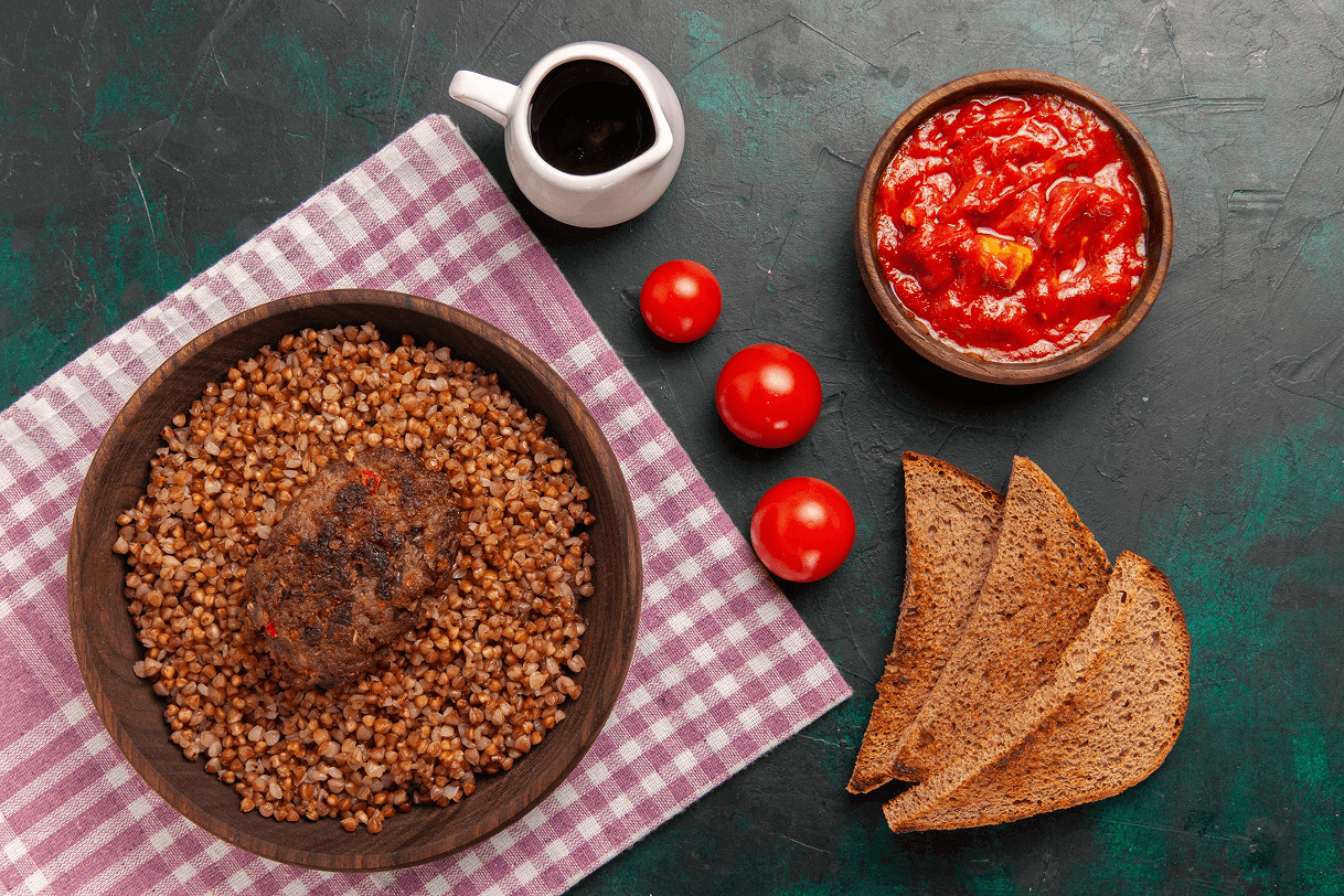 top-view-delicious-cooked-buckwheat-with-cutlet-bread-loafs-dark-green-surface-ingredient-meal-food-vegetable-dish 1