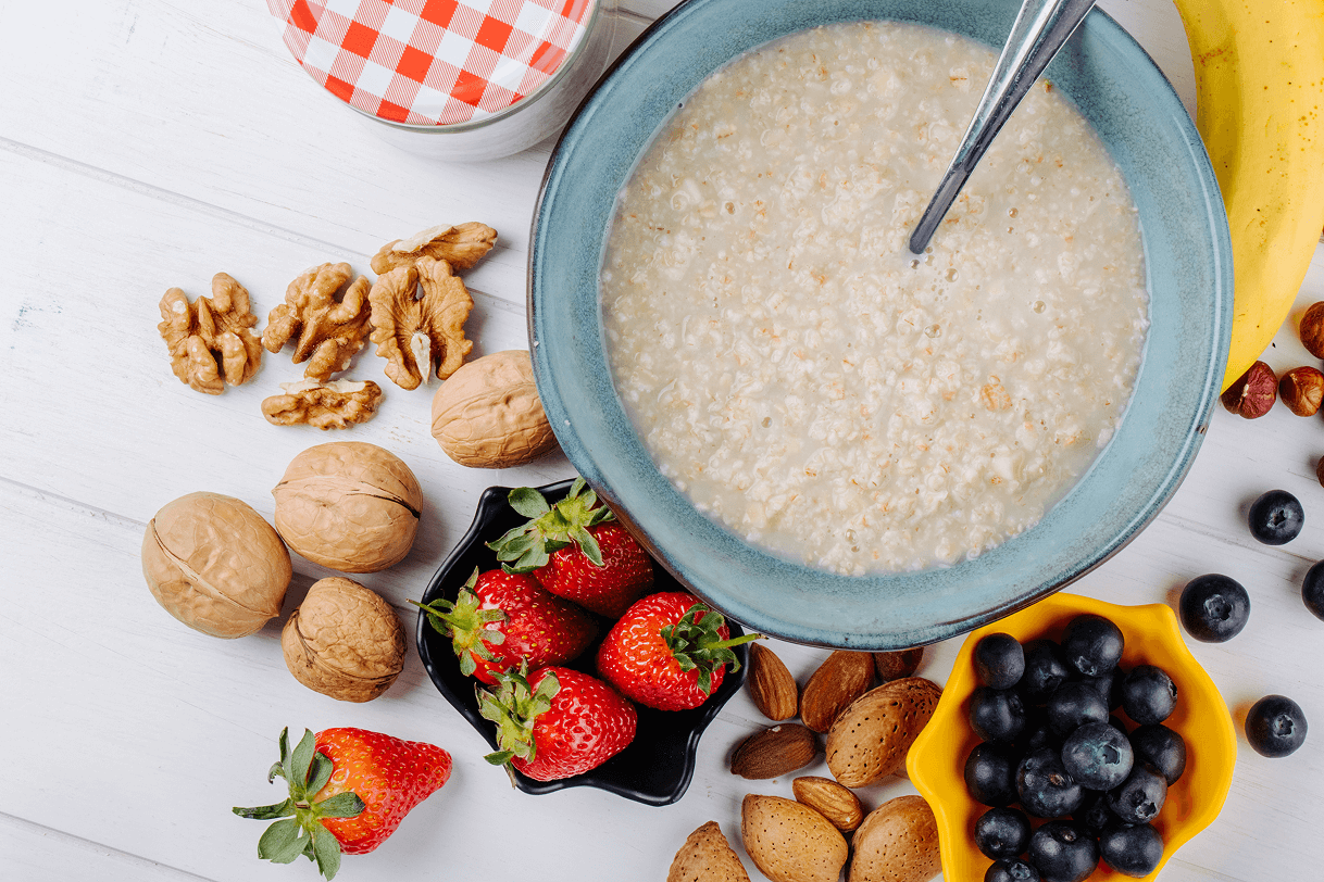 porridge-bowl-fresh-berries-nuts-wooden